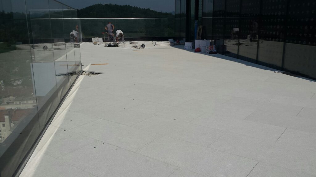 Porcelain Pavers Over Buzon Pedestals Create Level Decking Surface Free of Unsightly Conduit