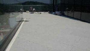 Porcelain Pavers Over Buzon Pedestals Create Level Decking Surface Free of Unsightly Conduit