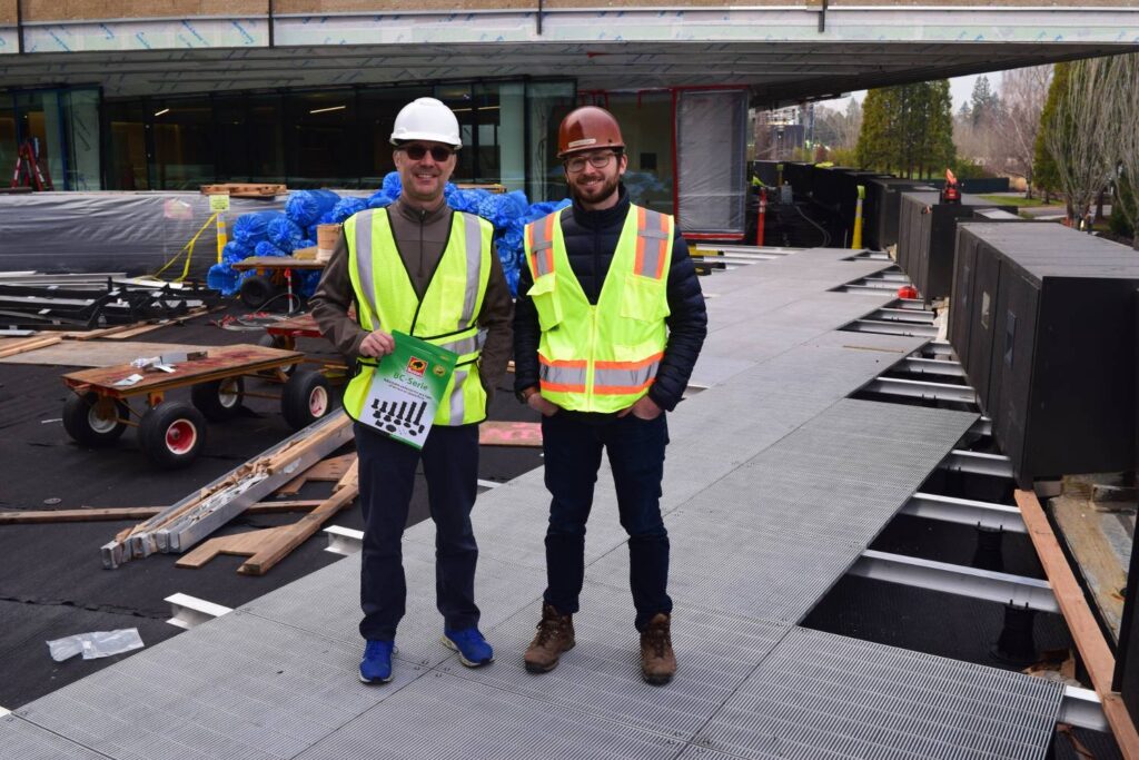 Erik Nelson Holding Up BC Series Brochure at Nike Merchandising Job Site