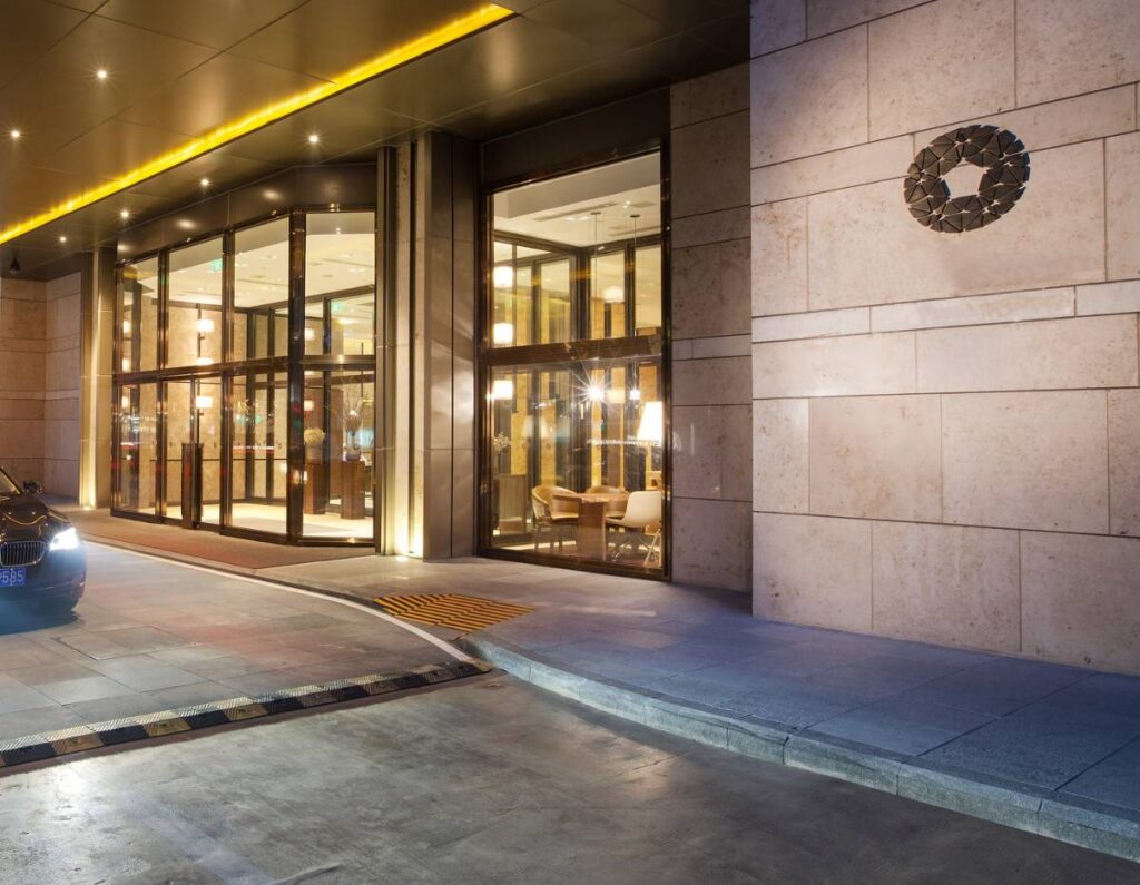 Driveway and Sidewalk Next to Building Entrance with Stone Pavers