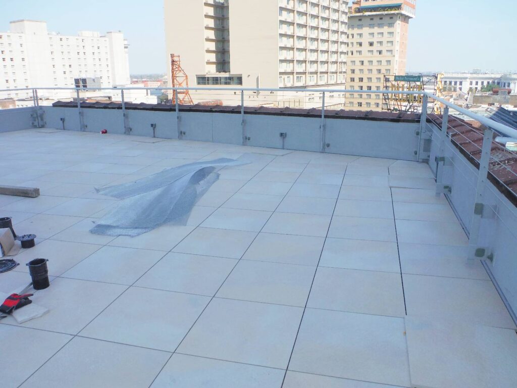 Level Porcelain Paver Rooftop Pool Deck with Parapet Wall and Angle Cuts Shown