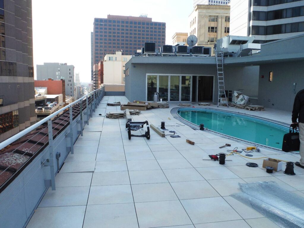 Rooftop Pool Deck with Porcelain Pavers and Parapet Wall Shown