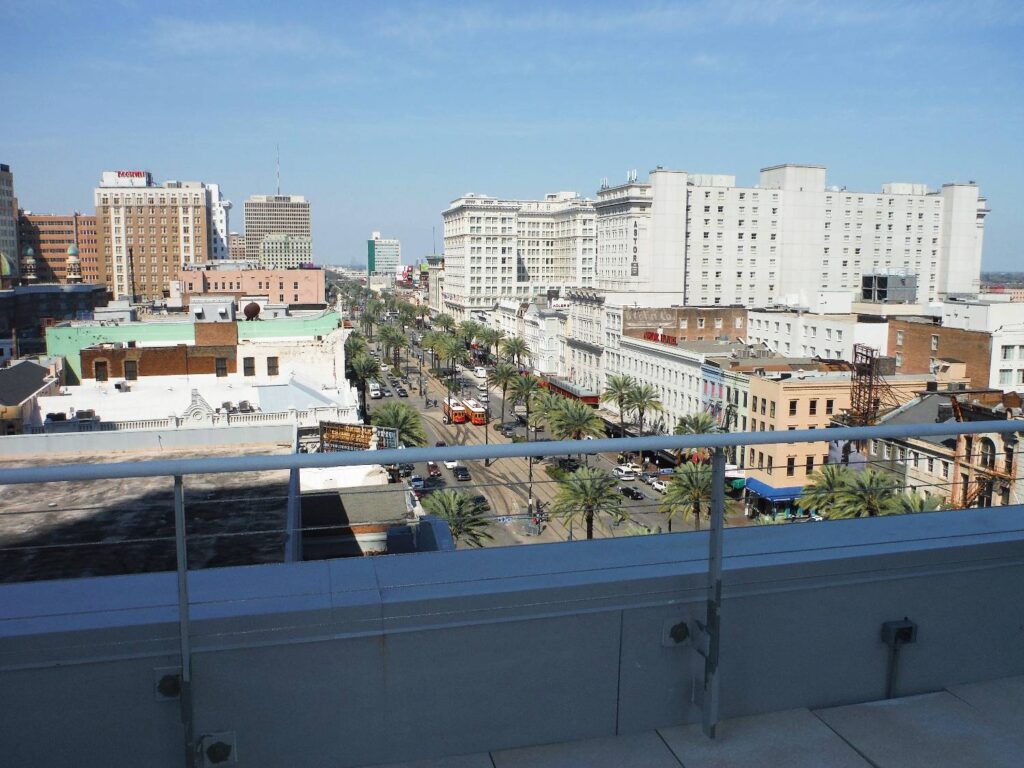 View Down Canal Street Looking Over Parapet Wall on Rooftop Pool Deck at Giani Building