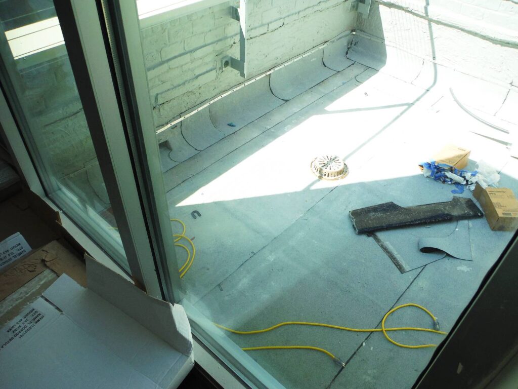 View Through Door to Rooftop Scupper Drain and Parapet Wall