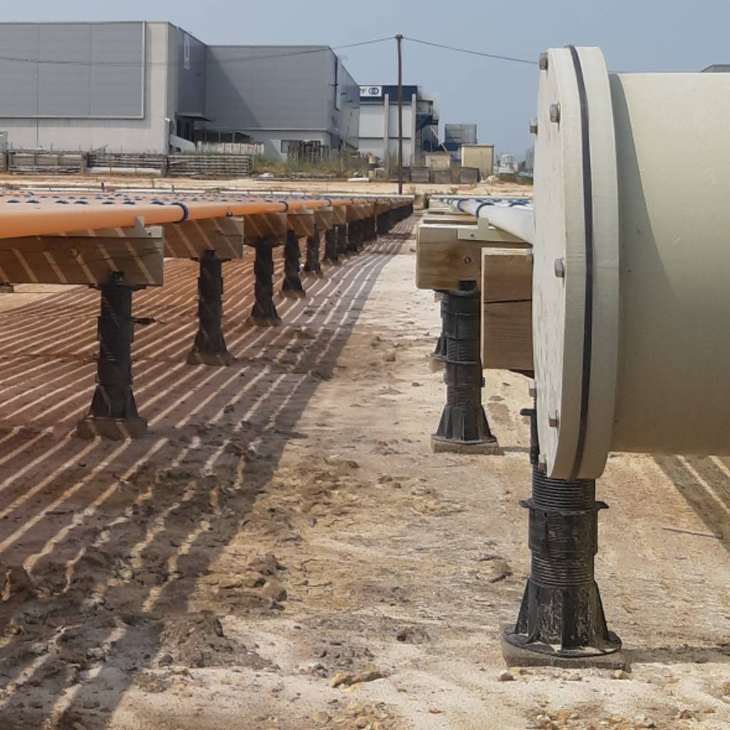 Close up of Buzon pedestals with joist kit accessory holding tubes in biotech application