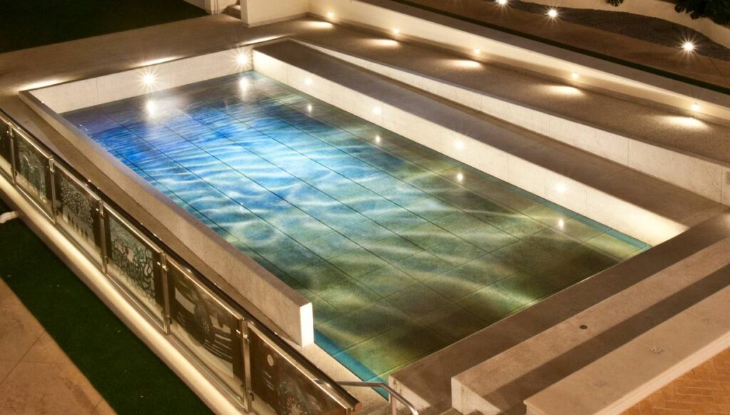 Sculpture Garden at Night with Glass Pavers Over Buzon Pedestals