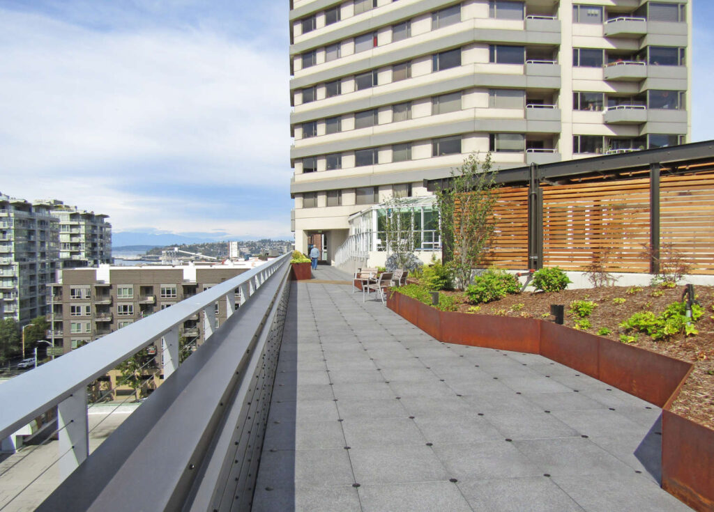 Rooftop Deck with Wind Protection on Pavers Near Parapet Wall