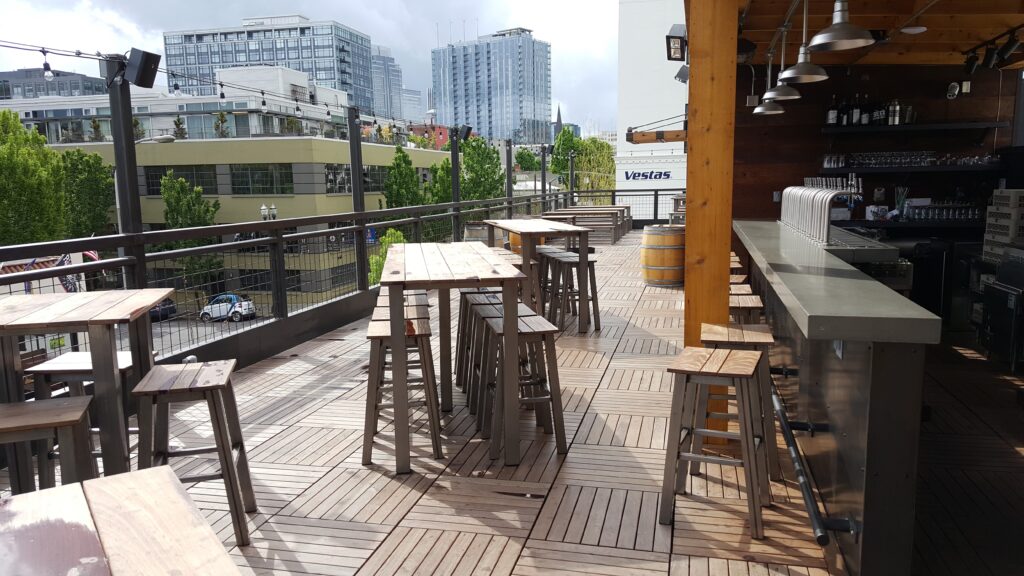 Rooftop deck at 10 Barrel Brewing using Buzon pedestal systems for architects with Ipe hardwood pavers.