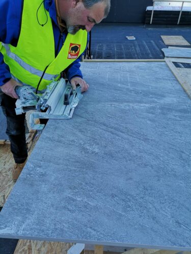 Kerf-cutting porcelain paver with grinder jig.