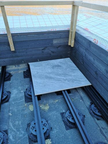 First corner porcelain paver installed on Buzon pedestal E-BRS Aluminum Joist Wind Uplift System.
