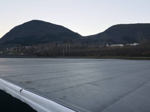 Large rooftop expanse with drain and taped seams about to receive Buzon E-BRS Easy Rail System and Wind Uplift Paver System.