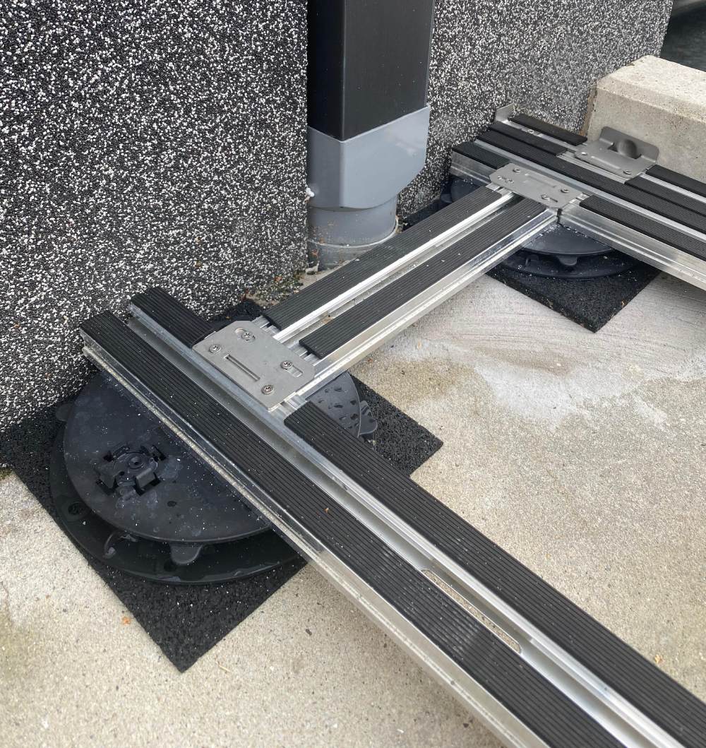 Paver Pedestal System with E-BRS Joist Over Buzon PB Pedestals on U-PAD Protective Rubber Pads.